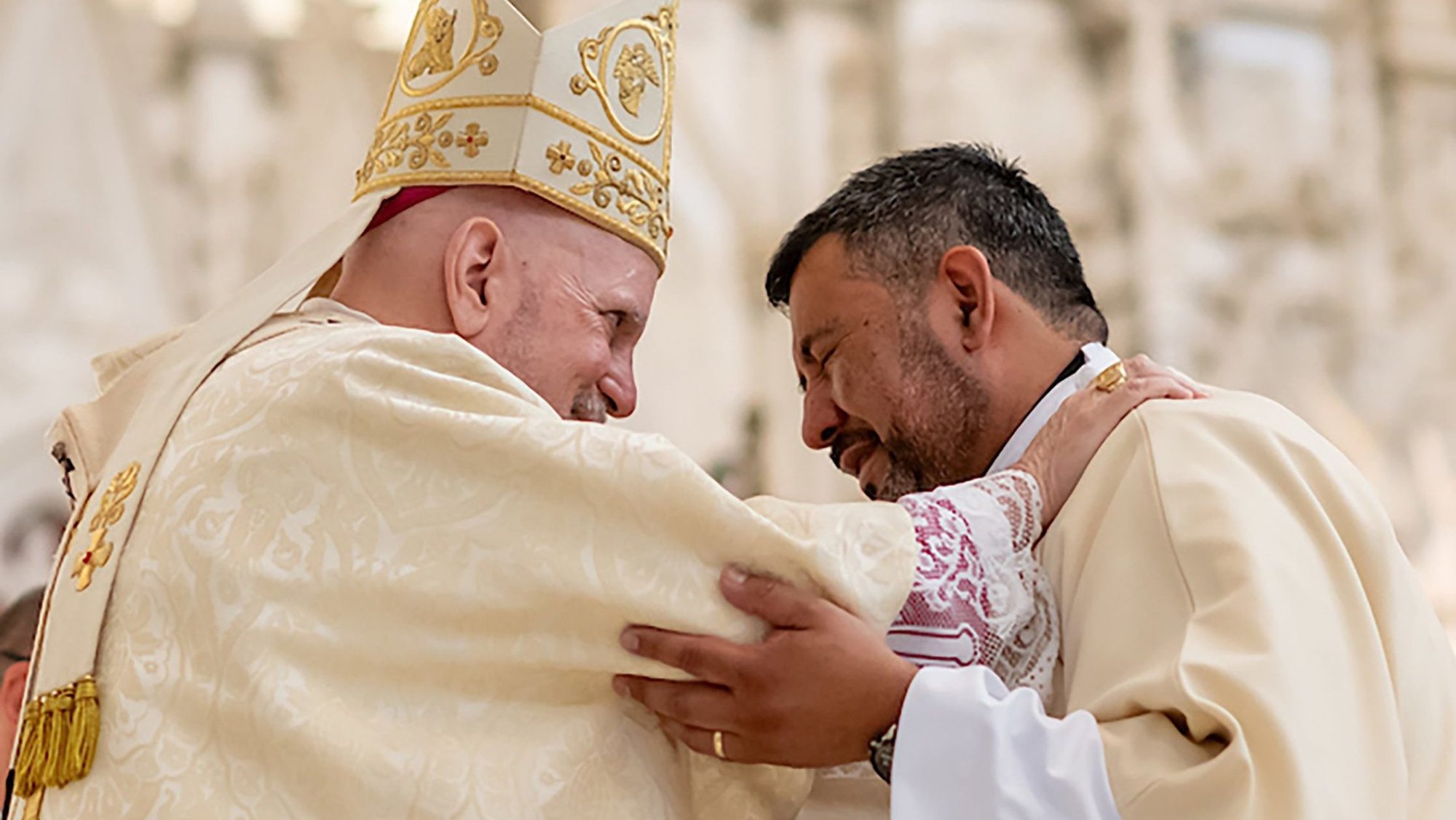 Denver Archbishop Samuel J. Aquila embraces Deacon Abram Leon during a permanent deacon ordination at the Cathedral Basilica of the Immaculate Conception in Denver June 14, 2025. (OSV News/Daniel Petty, Denver Catholic)