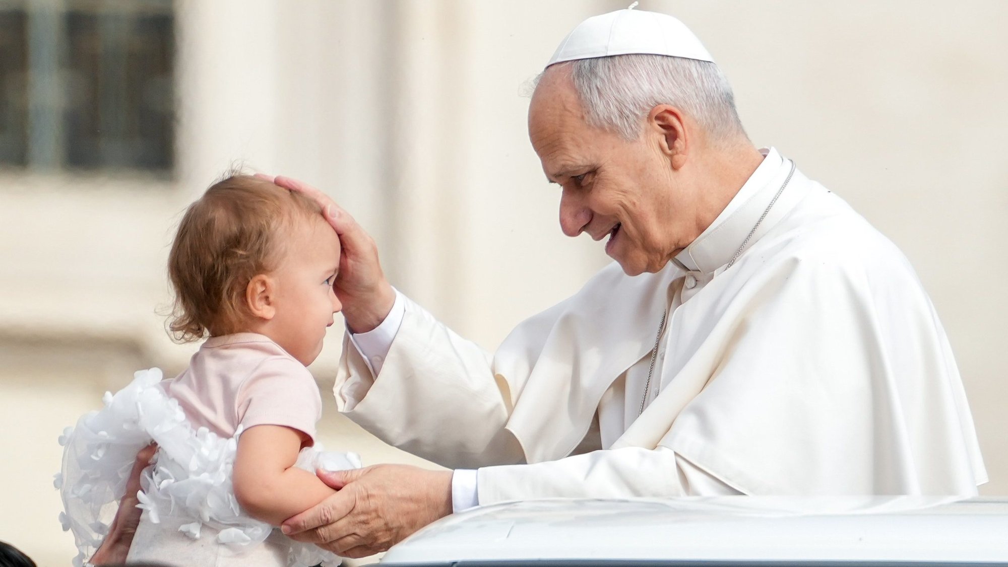 Pope Leo XIV greets a child from the popemobile while riding around St. Peter’s Square at the Vatican before his weekly general audience March 11, 2026. (CNS photo/Lola Gomez)