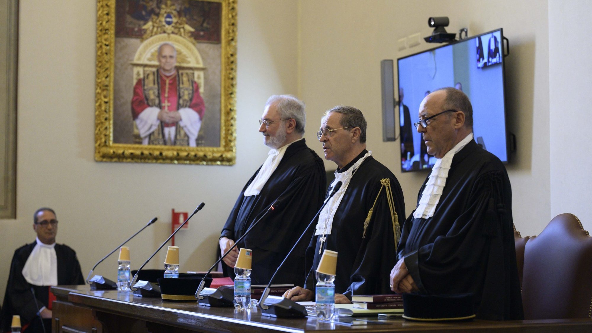 Archbishop Alejandro Arellano Cedillo, president of the Vatican City State Court of Appeals, stands between fellow judges Riccardo Turrini Vita and Massimo Massella Ducci Teri during the first hearing being held in the Vatican's new courtroom on the ground floor of the Apostolic Palace Sept. 22, 2025. The appeal was brought by Cardinal Angelo Becciu and eight other defendants convicted in late 2023 of crimes related to the Vatican's huge financial loss on an investment property in London. (CNS photo/Vatican Media)