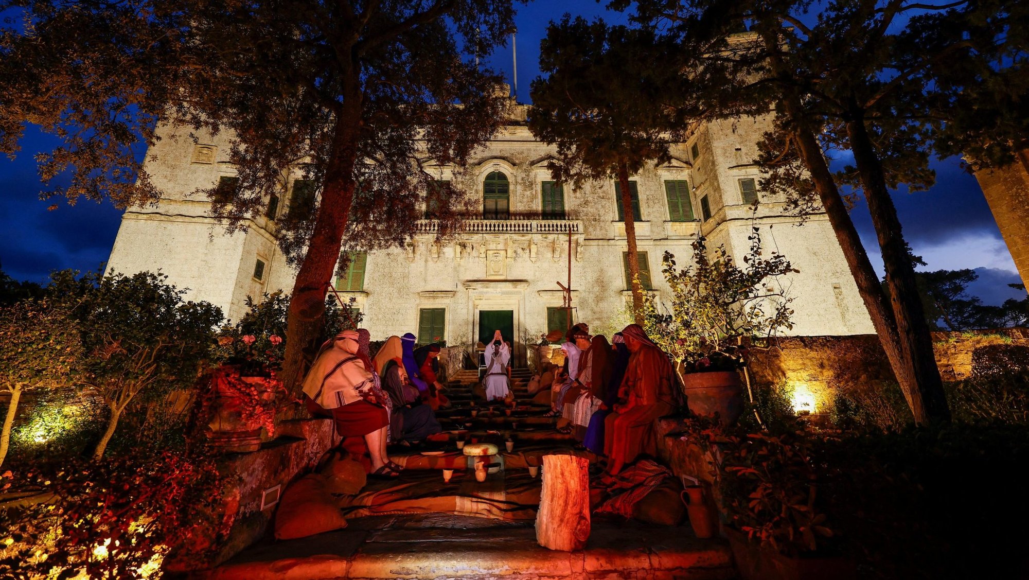 Actors perform the Last Supper scene during the interactive street theatre Passion play "Il-Mixja" (The Way), one of a series of Holy Week activities in the run-up to Easter, in the gardens of Verdala Palace outside Siggiewi, Malta, March 31, 2026. (OSV News photo/Darrin Zammit Lupi, Reuters)