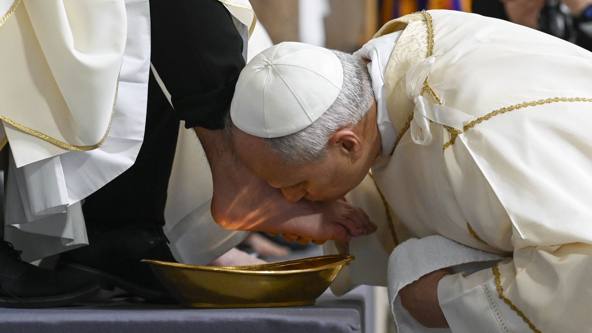 Pope Leo XIV kisses the foot of a priest during the Mass of the Lord's Supper at the Basilica of St. John Lateran in Rome April 2, 2026. The foot-washing ritual reflects the call to imitate Christ by serving one another. (CNS photo/Vatican Media)
