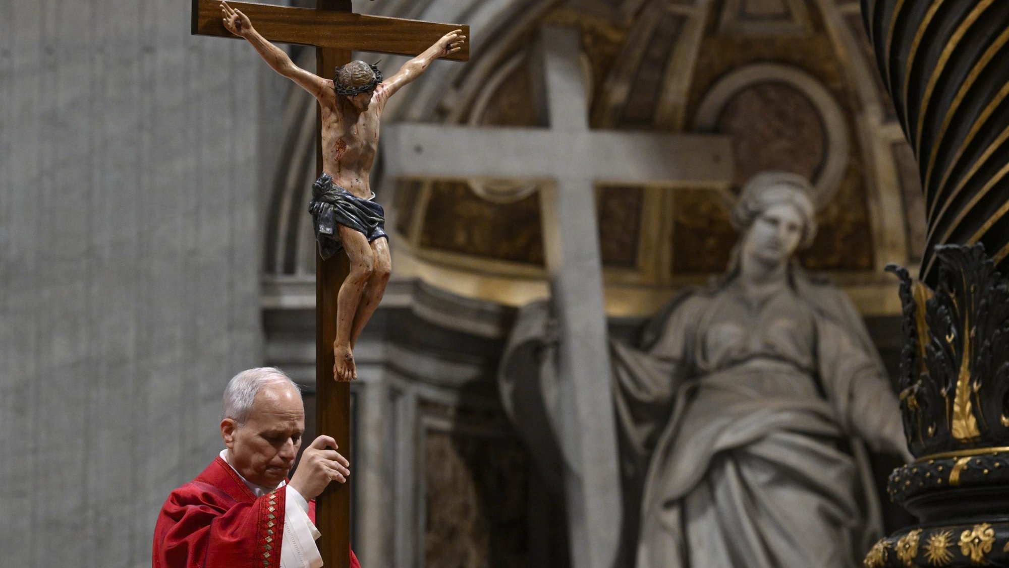 Pope Leo XVI holds a crucifix as he leads the Good Friday Liturgy of the Lord's Passion in St. Peter's Basilica at the Vatican April 3, 2026. (OSV News photo/Simone Risoluti, Vatican Media)