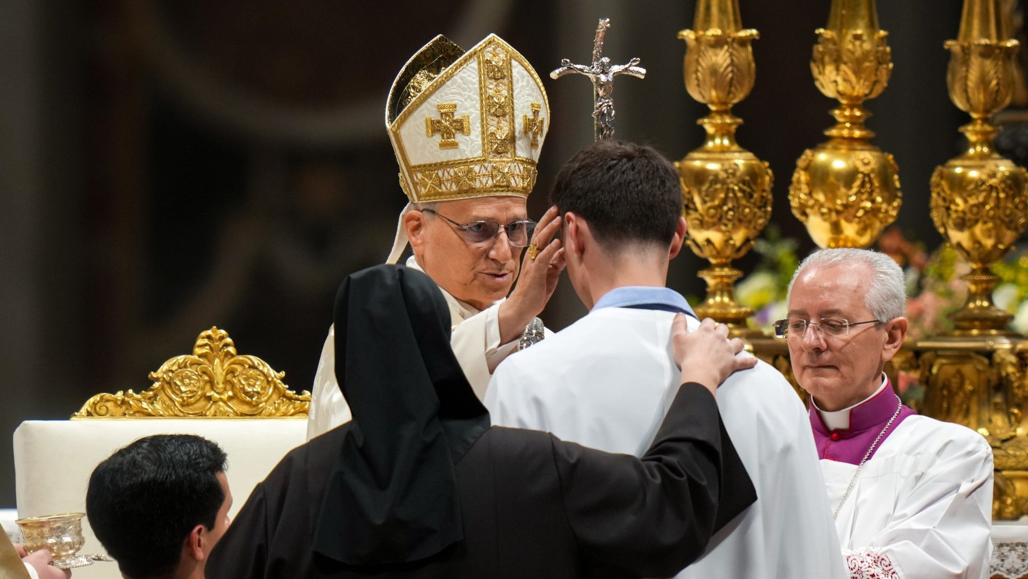 Pope Leo XIV confirms a man he baptized during the Easter Vigil Mass in St. Peter's Basilica at the Vatican April 4, 2026. (CNS photo/Lola Gomez)