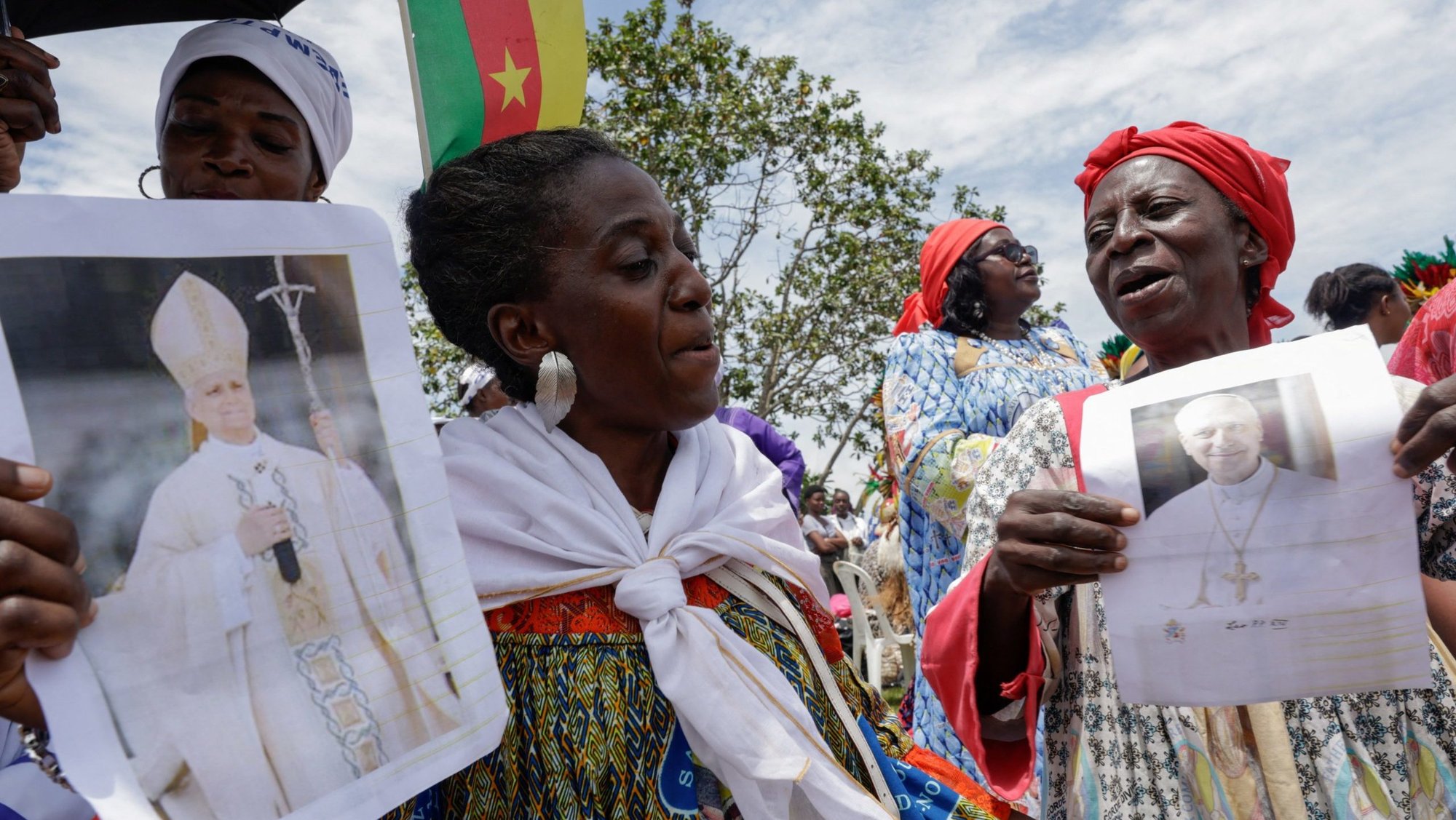 Women hold portraits of Pope Leo XIV at Yaounde Nsimalen International Airport in Yaounde, Cameroon, April 15, 2026, ahead of the pontiff's arrival to begin his apostolic journey to the African country. Late on April 13, separatist factions operating in Cameroon's Anglophone regions announced a temporary cessation of hostilities would be in place during the papal visit. (OSV News photo/Luc Gnago, Reuters)