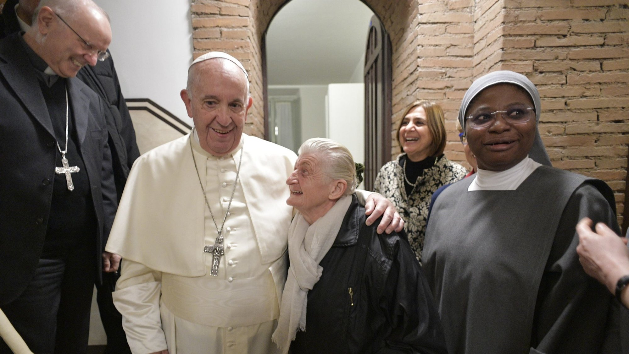 Pope Francis embraces a woman as he inaugurates a new shelter, day center and soup kitchen for the poor in Palazzo Migliori across the street from St. Peter's Square Nov. 15, 2019. The shelter, funded by the papal almoner's office, will be staffed by volunteers from the Community of Sant'Egidio and was inaugurated in time for the World Day of the Poor. (CNS photo/Vatican Media)