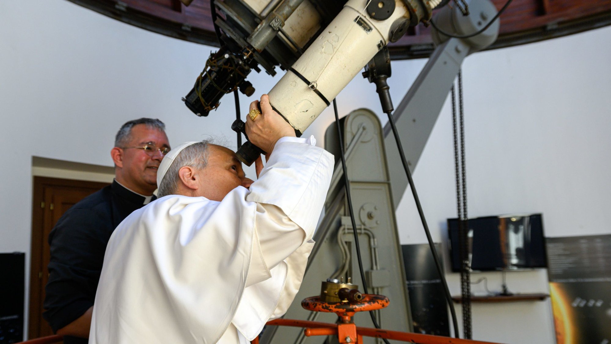 Pope Leo XIV looks through the main telescope of the Vatican Observatory in Castel Gandolfo, Italy, alongside U.S. Jesuit Father David A. Brown, an astronomer, July 20, 2025. The Vatican Observatory announced April 29, 2026, that an asteroid has been named in honor of Pope Leo XIII, who formally re-established the observatory in 1891. (CNS photo/Vatican Media)