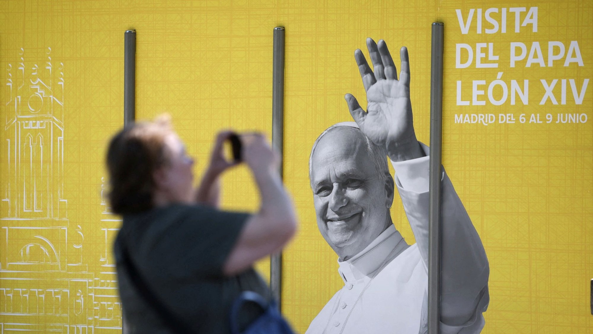 A woman in Madrid takes a picture of a poster of Pope Leo XIV May 28, 2026, ahead of the pontiff's June 6-12 apostolic visit to Spain. (OSV News photo/Kacper Pempel, Reuters)