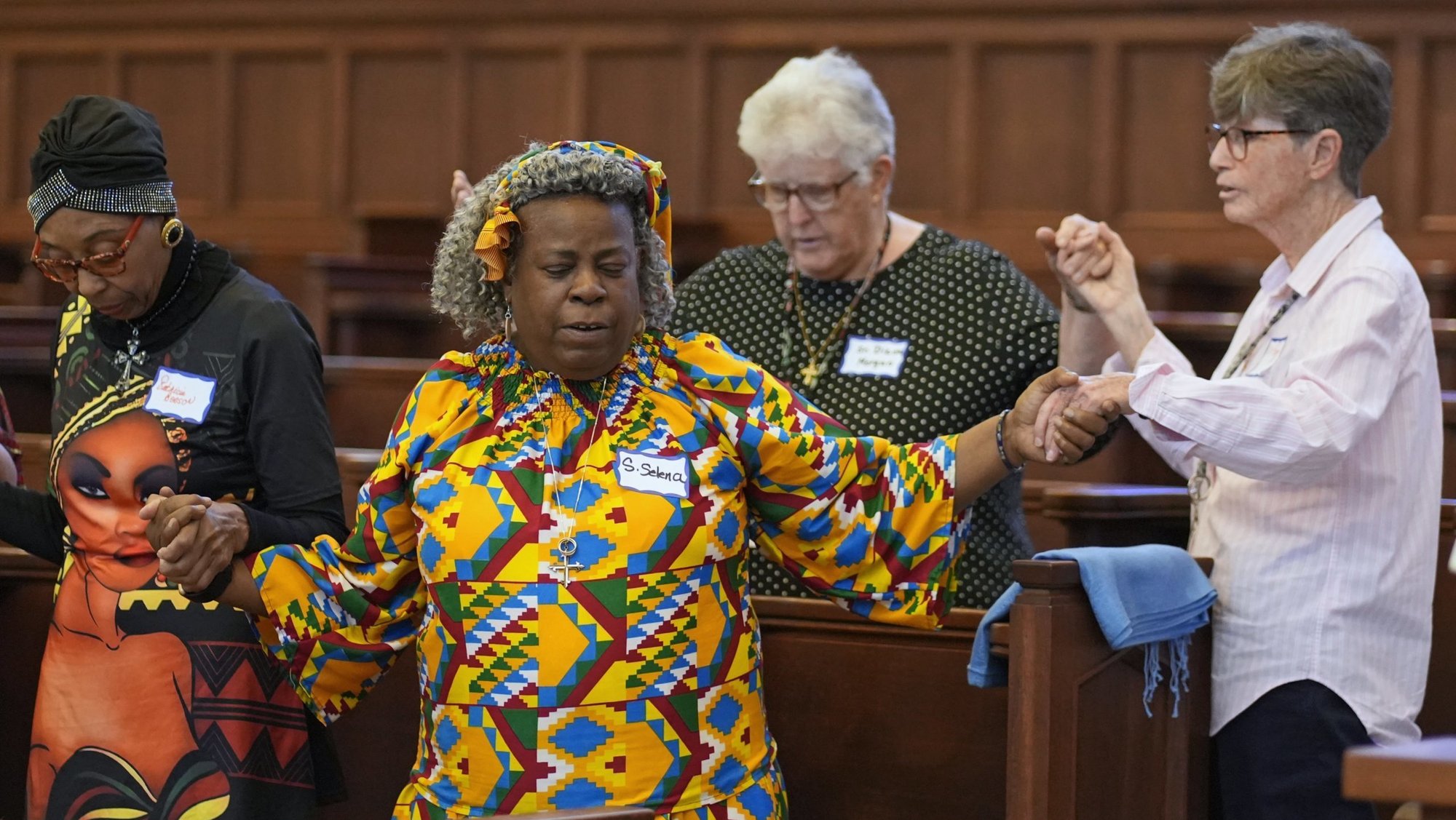 Participants hold hands as they recite the Lord's Prayer during a prayer service at the motherhouse of the Sisters of St. Dominic of Amityville, N.Y., June 19, 2025. The Dominican Sisters hosted the event to celebrate Juneteenth (June 19) and World Refugee Day (June 20). (OSV News photo/Gregory A. Shemitz)