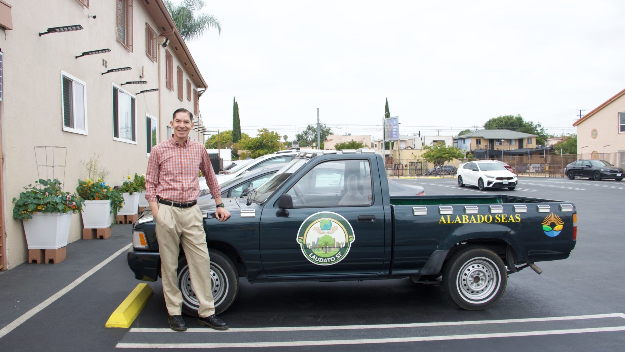 Father Ricardo Gonzalez, SVD, pastor at Our Lady of Lourdes Church in East LA, stands by his Laudato Si’ truck that helps him carry everything from plants, clothing, or furniture. (Kimmy Chacon)