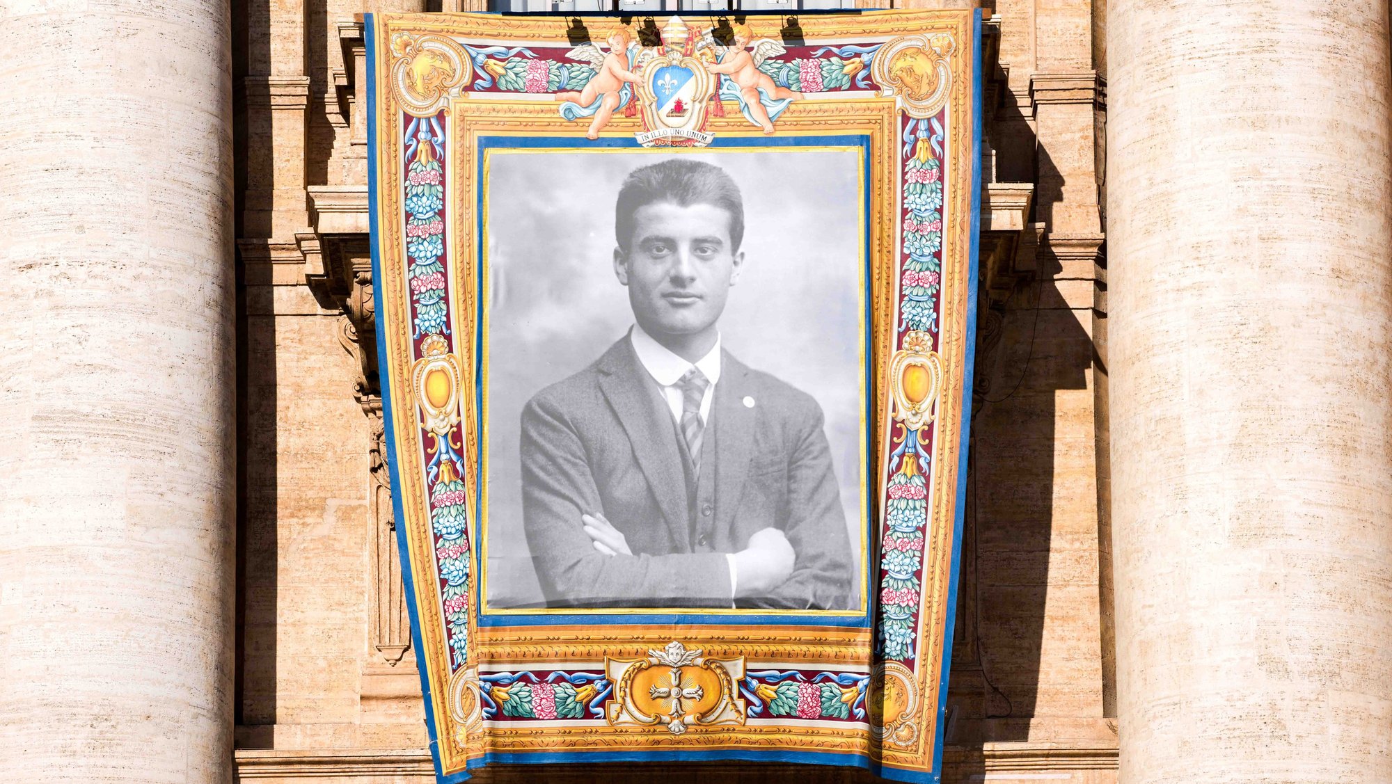 A tapestry depicting St. Pier Giorgio Frassati hangs from the facade of St. Peter’s Basilica during the Mass for his canonization at the Vatican Sept. 7, 2025. (CNS photo/Lola Gomez)