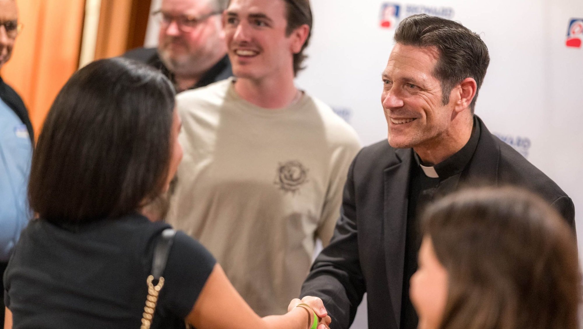 Father Mike Schmitz, a diocesan priest in the Diocese of Duluth, Minn., and a popular priest on social media,, meets with young adults from St. David Catholic Church in Davie, Fla., at the Broward Center for the Performing Arts in downtown Fort Lauderdale, Fla., May 20, 2026. Father Schmitz spoke in three Florida cities that month as part of his Parables Tour. His last tour date is July 20 in Dublin. (OSV News photo/Tom Tracy)