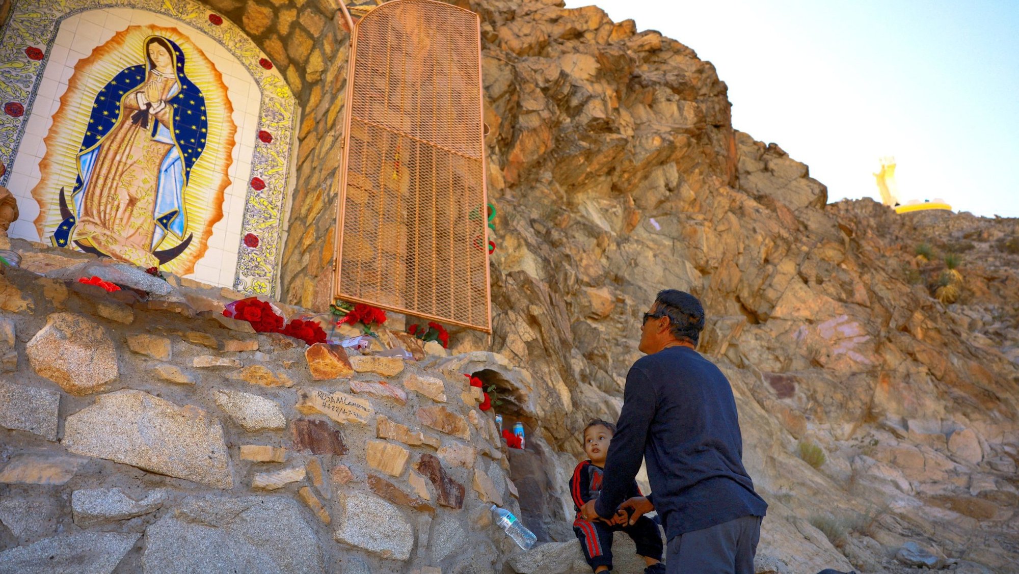A man prays with a child in front of an image of Our Lady at Mount Cristo Rey in Sunland Park, N.M., during a pilgrimage Nov. 23, 2024, for the feast of Christ the King. (OSV News photo/Jose Luis Gonzalez, Reuters)