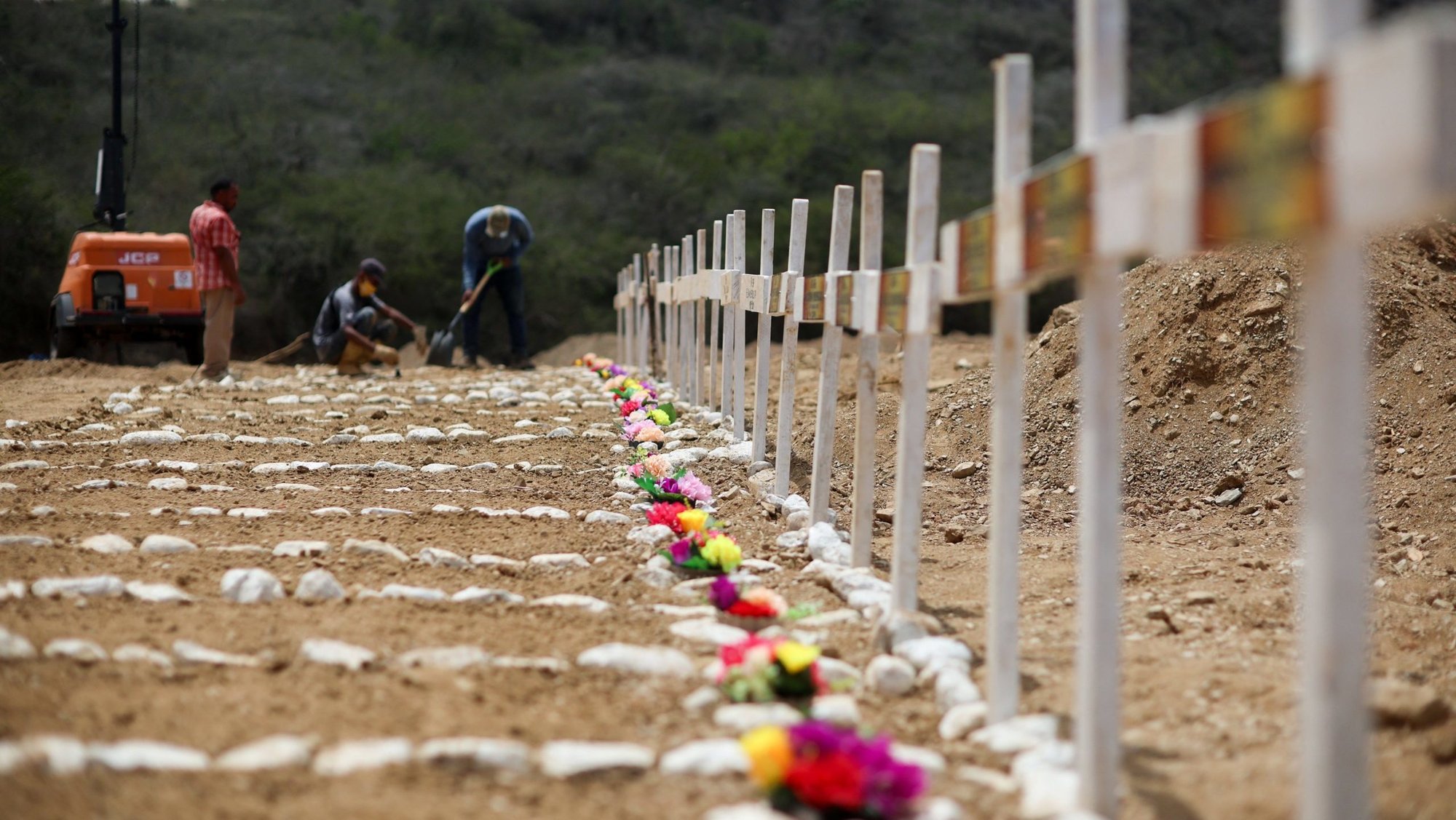 Workers prepare graves on the day of a mass burial for earthquake victims at La Esperanza Cemetery in La Guaira, Venezuela, July 6, 2026. Two catastrophic earthquakes hit Venezuela in quick succession June 24, leaving at least 5,000 dead with thousands still missing. (OSV News photo/Adriano Machado, Reuters)