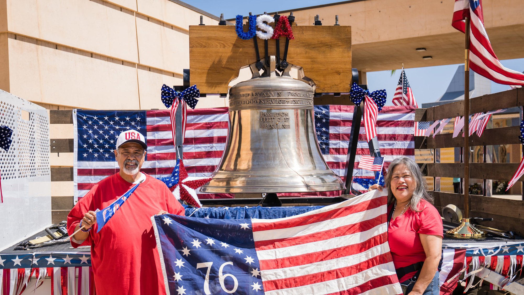 Attendees at the Mass for the Nation pose in front of a 2,500-pound replica Liberty Bell in the outdoor plaza at the Cathedral of Our Lady of the Angels on July 3. (Isabel Cacho)