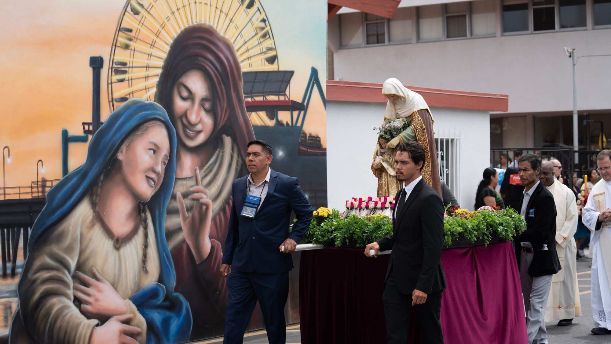 Parishioners process to St. Anne Shrine in Santa Monica before a July 26 Mass marking the saint’s feast day. At left is a mural dedicated in 2024 depicting St. Anne holding her child, the Blessed Virgin Mary. (Poncho Romero)