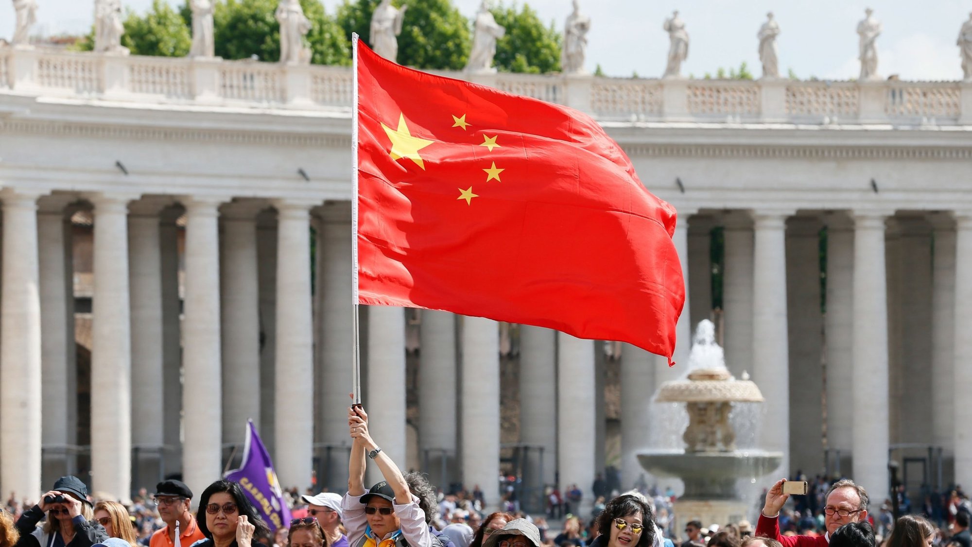 A visitor waves the flag of China in St. Peter's Square at the Vatican in this file photo from May 22, 2019. (CNS photo/Paul Haring