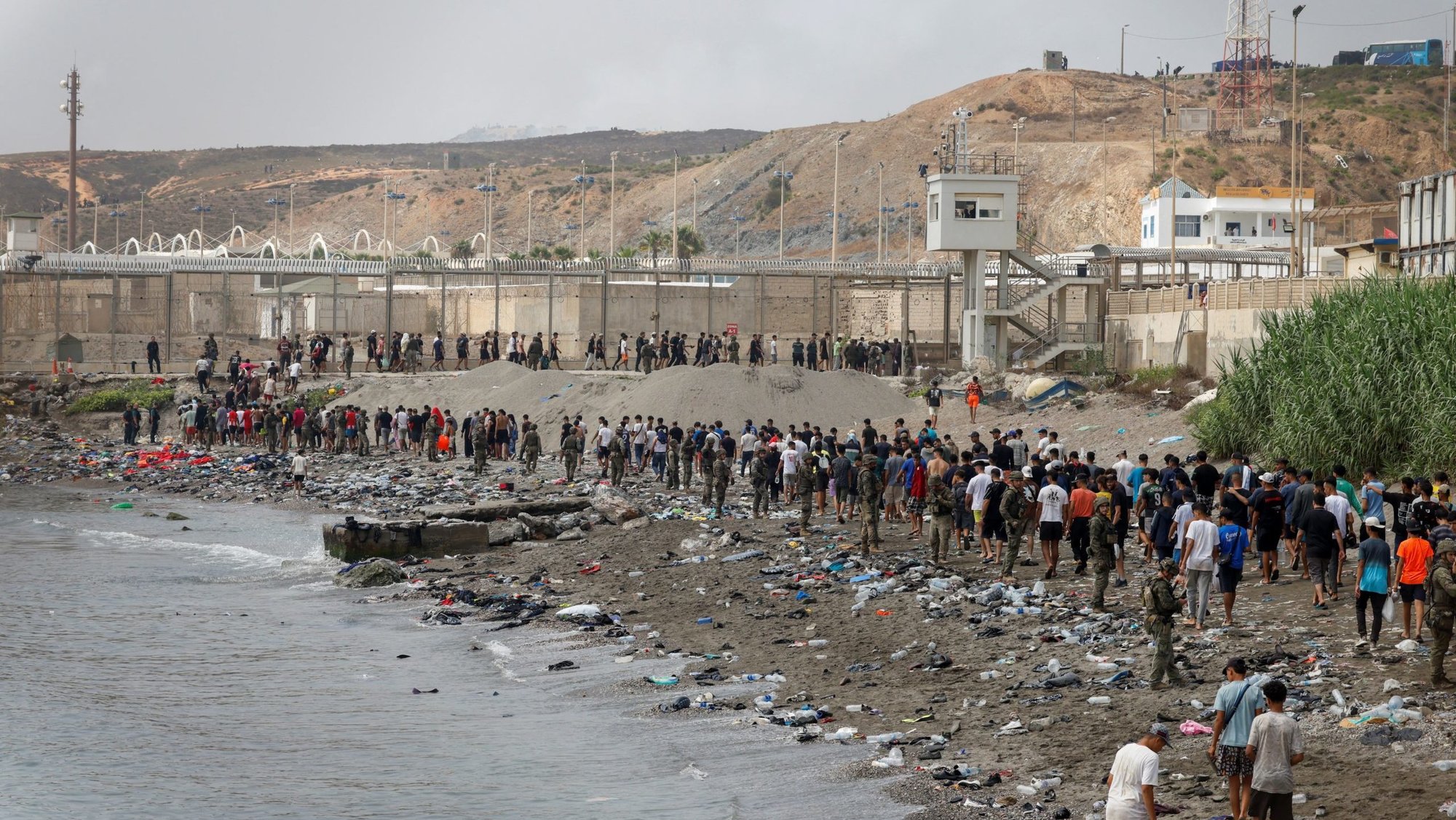 People in Ceuta, Spain, walk toward the country's border with Morocco July 31, 2026, leaving Spain amid mass crossings of migrants on foot and by sea from Morocco into Spanish territory. The Diocese of Cádiz and Ceuta offered emergency resources to civil authorities July 31 as more than 40,000 migrants crossed from Morocco into the Spanish exclave of Ceuta, straining local infrastructure. (OSV News/Jon Nazca, Reuters)
