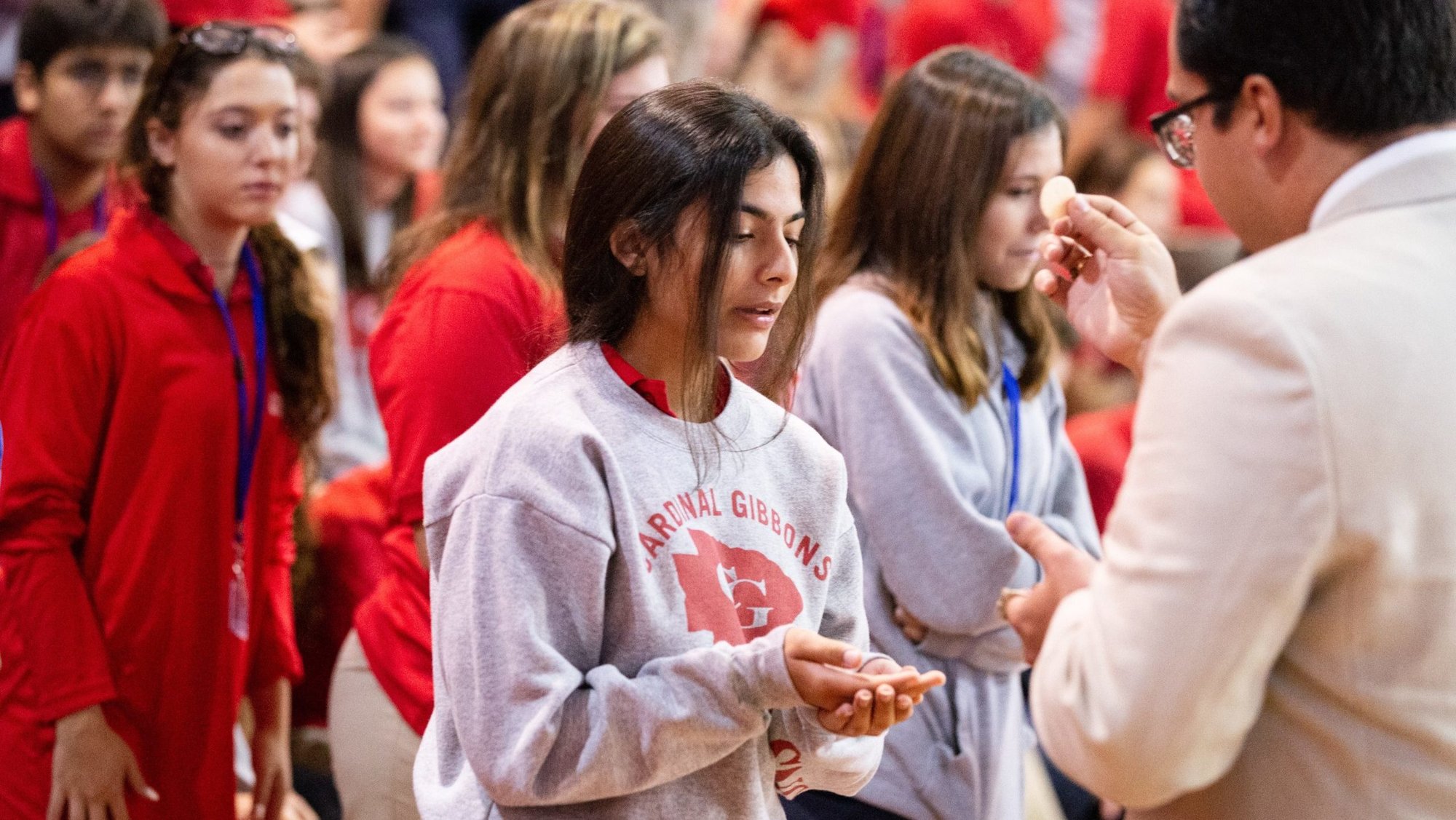 A file photo shows students at Cardinal Gibbons High School in Fort Lauderdale, Fla., receiving Communion during a Mass and rally for the opening of the school year. Florida Attorney General James Uthmeier sent a letter July 31, 2026, to the Catholic bishops of Florida demanding that Catholic schools in the Sunshine State adopt religious exemptions to vaccine requirements or risk their ability to participate in the state's school voucher program. (OSV News photo/Tom Tracy)