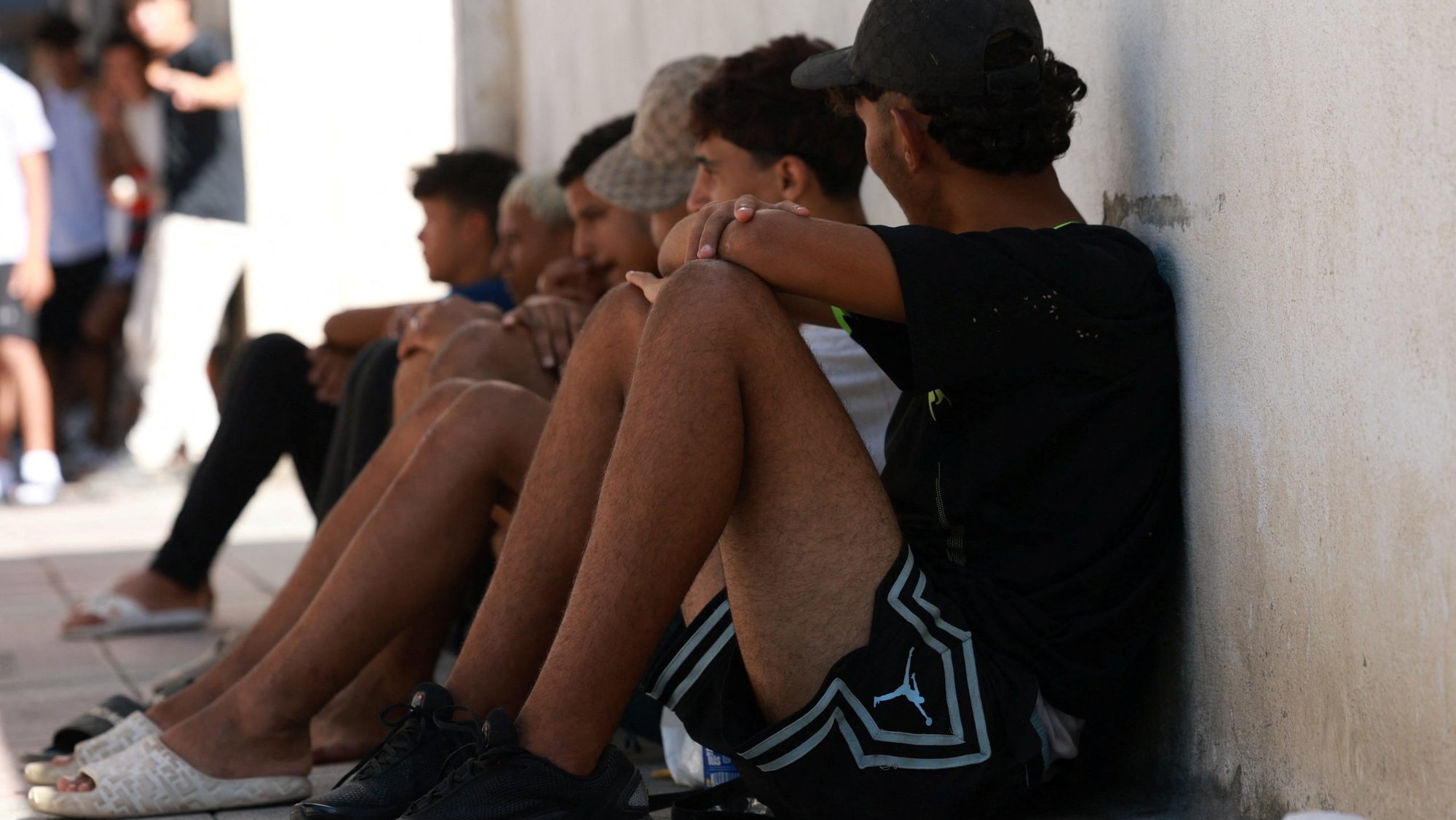 Migrant children wait outside a police station in Ceuta, Spain, Aug. 6, 2026, to be registered following mass crossings by migrants on foot and by sea from Morocco into Spanish territory. (OSV News photo/Violeta Santos Moura, Reuters)