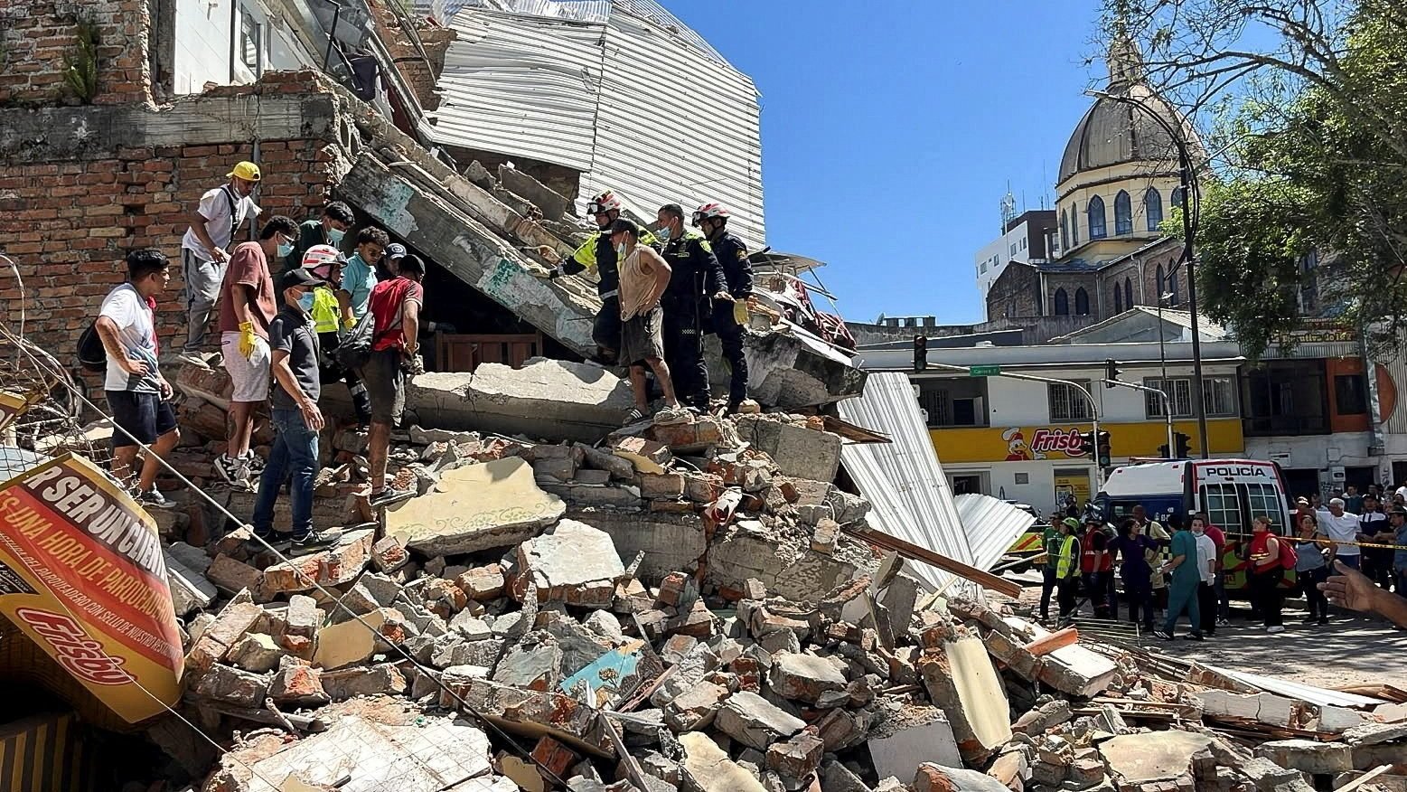 Residents and emergency personnel dig through the debris of a partially collapsed building after an earthquake, in Pereira, Colombia Aug. 10, 2026. (OSV News photo/Stringer, Reuters)
