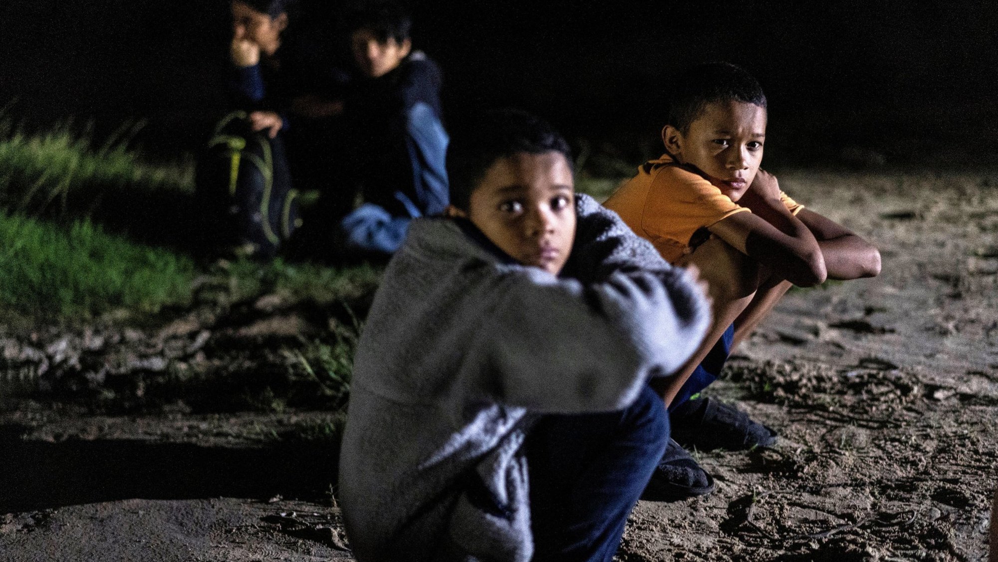 Unaccompanied minors who are migrants from Honduras sit on the riverbank in Roma, Texas, after crossing the Rio Grande July 9, 2021. (OSV News photo/Go Nakamura, Reuters)
