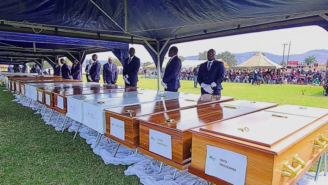 A pallbearer stands next to a line of coffins during a memorial service at Nyamhunga Stadium in Kariba, Zimbabwe, Aug. 13, 2026, for victims of a Rural Infrastructure Development Agency (RIDA) passenger ferry that capsized on Lake Kariba. In a telegram published Aug. 18, Pope Leo XIV expressed his condolences to the families of the victims of the tragic Aug. 11 ferry accident that has killed more than 90 people. (OSV News photo/Bright Charakupa, Reuters)