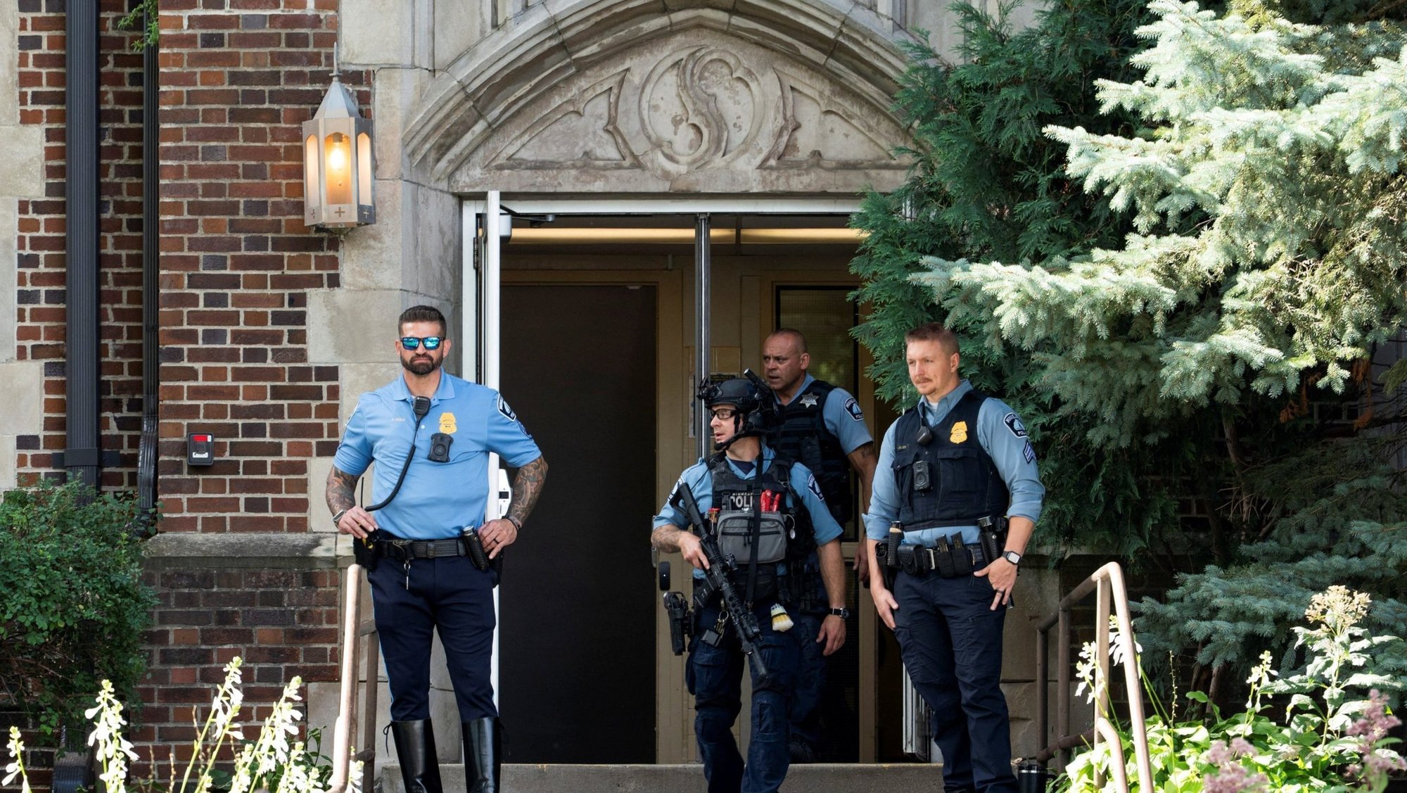 Following a shooting at Annunciation Church, first responders stand at the entrance to nearby Annunciation Catholic School in Minneapolis Aug. 27, 2025. A shooter opened fire with a rifle through the windows of the church and struck children attending Mass during the first week of school, killing two and wounding two dozen others in an act of violence the police chief called "absolutely incomprehensible." (OSV News photo/Tim Evans, Reuters)