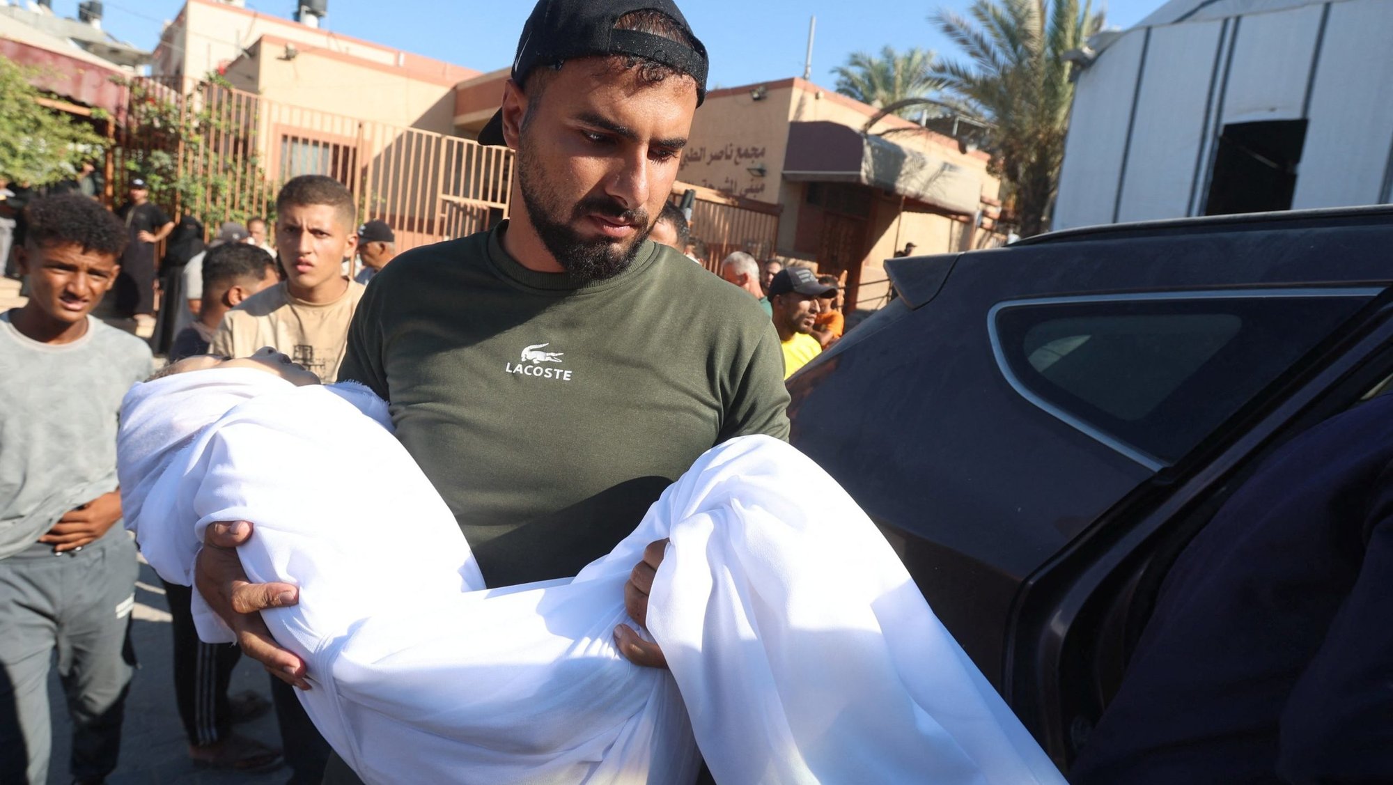 A man carries the body of of a 10-year-old Palestinian girl during her funeral in the southern Gaza Strip, Aug. 24, 2026. She was shot in the back while eating inside her family's tent and later died at Nasser Hospital in Khan Younis, according to medics and relatives. A network of Catholic priests in Africa has become the latest group to declare genocide in Gaza, as the United Nations reports continuing airstrikes, deaths and injuries, amid a shaky ceasefire in the area. (OSV News photo/Ramadan Abed, Reuters)