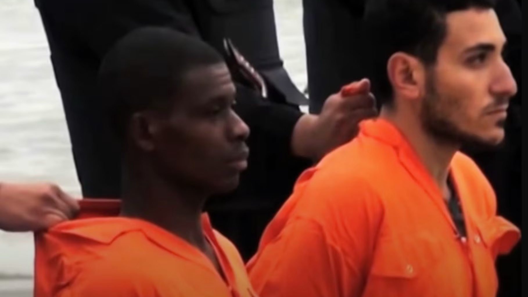 St. Matthew Ayariga, left, and another captive being held by ISIS terrorists on Feb. 15, 2015. “Vaticano”/Screenshot via EWTN)