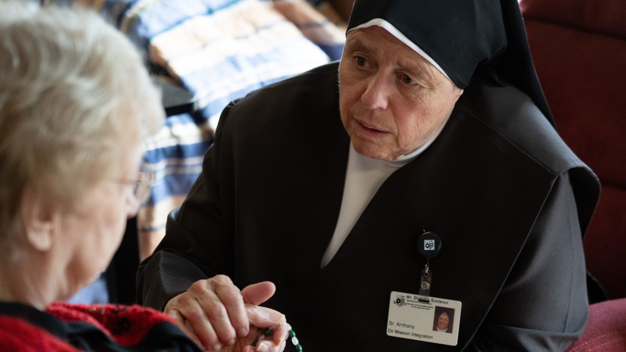 A Carmelite Sister comforts a resident Aug. 21, 2026, at St. Patrick’s Residence in Naperville, Ill. Cardinal Blase J. Cupich of Chicago, the Carmelite Sisters for the Aged and Infirm and the Chicago Province of the Little Sisters of the Poor, and an Illinois pharmacist sued Illinois Sept. 3 over the state's physician-assisted suicide law, which permits physicians to aid terminally ill adults in dying by suicide. (OSV News photo/courtesy Becket)