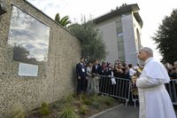 Pope Leo XIV stops to view a memorial plaque for victims of clerical sexual abuse at Lourdes