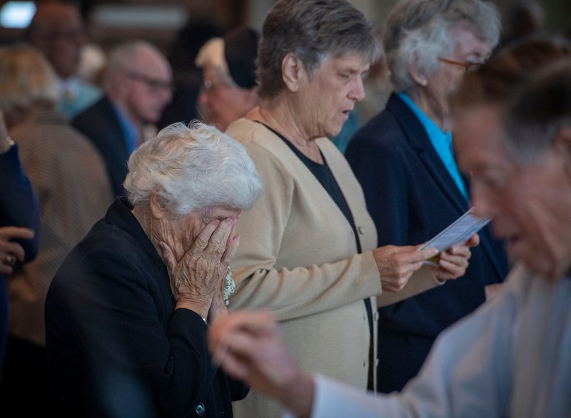 A woman prays during Mass for the 100th anniversary of the Daughters of Mary & Joseph order.