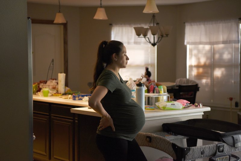 A pregnant woman at her home