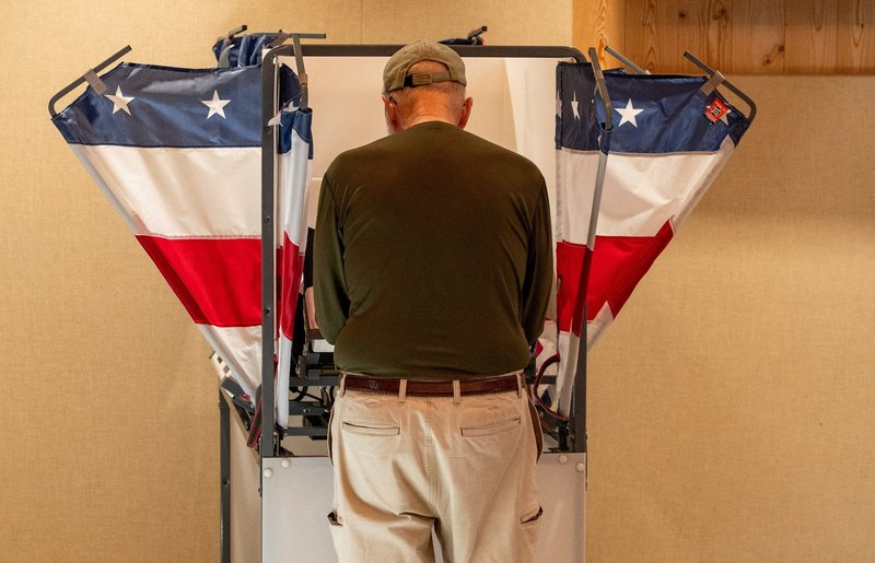 A person votes at a polling station