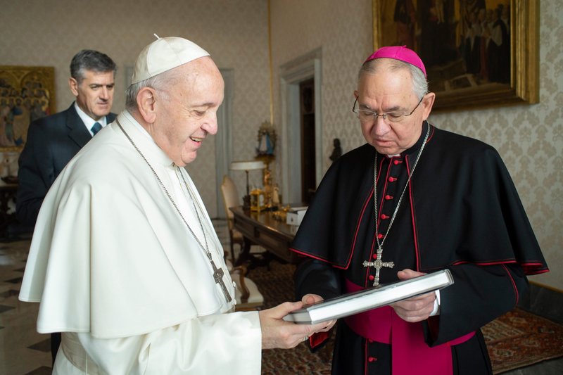 Archbishop José H. Gomez of Los Angeles presents Pope Francis with a copy of the book "The Spirit Within Saint Junipero," during a meeting with bishops from California, Hawaii and Nevada on their "ad limina" visit to the Vatican Jan. 27, 2020. The book is a collection of photographs that presents "close and detailed views of the places that formed" St. Junípero Serra, whom Francis canonized in 2015. (CNS photo/Vatican Media)
