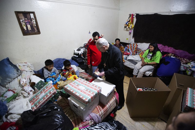 Archbishop José H. Gomez delivers Christmas presents to a family near downtown LA in December 2019. (Victor Alemán)