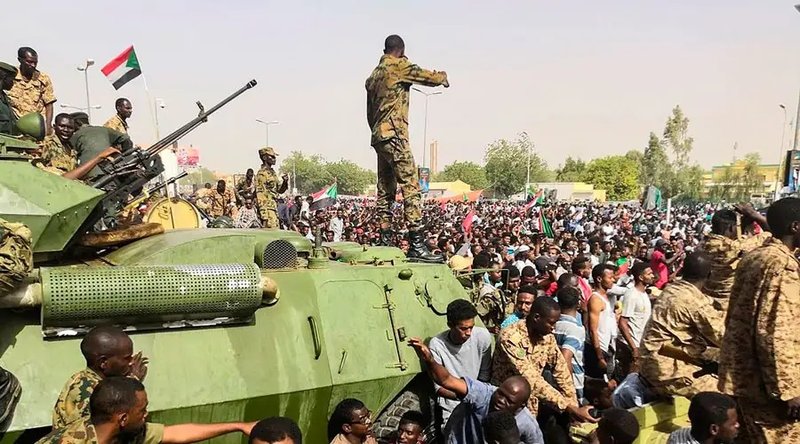 Soldados sudaneses montan guardia alrededor de vehículos militares blindados mientras los manifestantes continúan su protesta contra el régimen (2019) / (Foto: ACI/Agence France-Presse - Dominio Público)