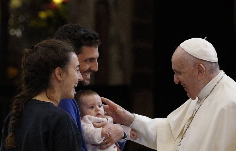 El papa Francisco saluda a una familia durante un encuentro con los pobres en la Basílica de Santa María de los Ángeles en Asís, Italia, el 12 de noviembre de 2021. Durante el Ángelus del 26 de diciembre, el papa dijo que había escrito una carta a las familias como "regalo de Navidad." (Foto CNS/Paul Haring)