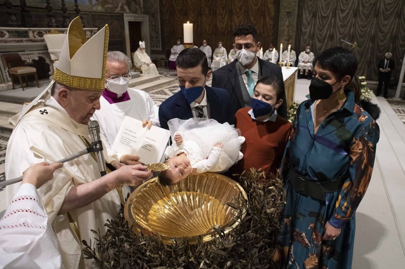 El papa Francisco bautiza a un bebé durante la misa que marca la fiesta del Bautismo del Señor en la Capilla Sixtina en el Vaticano el 9 de enero de 2022. El papa bautizó a 16 niños. (Foto CNS/Vatican Media)