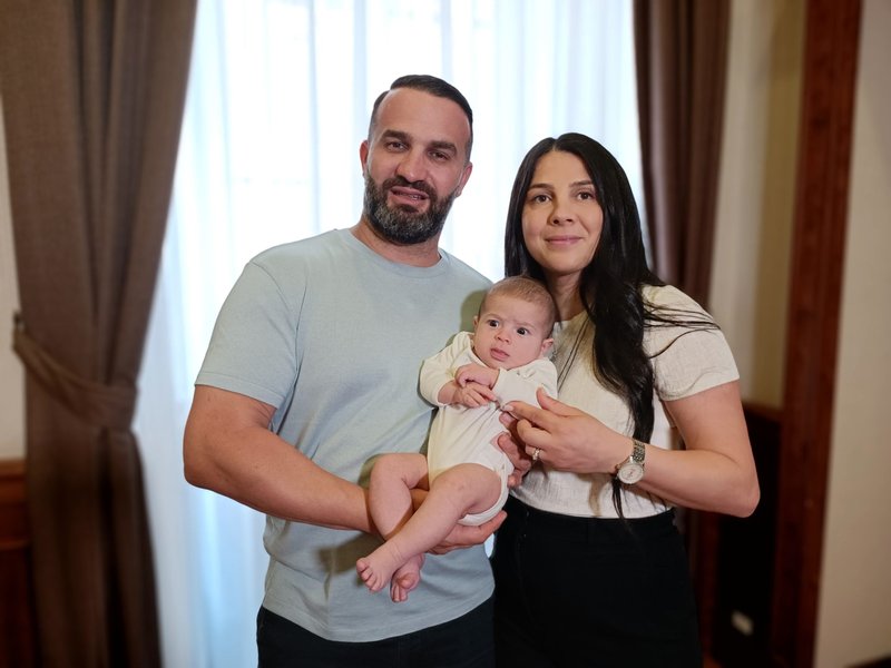 Danny and Leila Abdallah pose for a photo with 3-month-old Selina at the Domus Australia in Rome June 24, 2022. The Abdallahs were scheduled to speak June 25 at the World Meeting of Families at the Vatican about the tragic deaths of three of their children in 2020 and how they forgave the drunk driver who killed them. (Foto CNS /Robert Duncan)