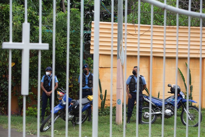 Nicaraguan police officers keep watch outside a Catholic church in Managua where Bishop Rolando José Álvarez of Matagalpa was taking refuge after he had been targeted by the police, May 20, 2022. Police in Matagalpa currently have Bishop Álvarez and a group of priests and lay Catholics under house arrest. (Credit: CNS photo/Maynor Valenzuela, Reuters.)
