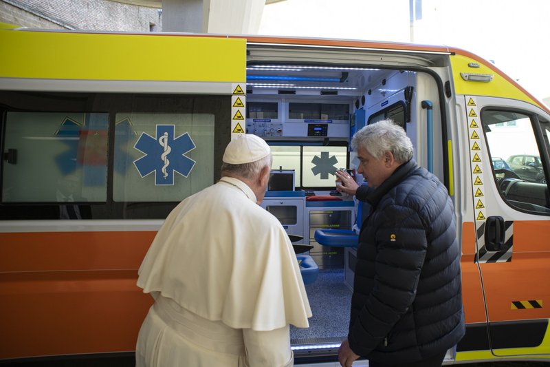 El papa Francisco habla con el cardenal Konrad Krajewski, limosnero papal, durante la bendición de una ambulancia para donar a la ciudad ucraniana de Lviv, en el Vaticano, en esta foto de archivo del 26 de marzo de 2022. (CNS/Vatican Media)