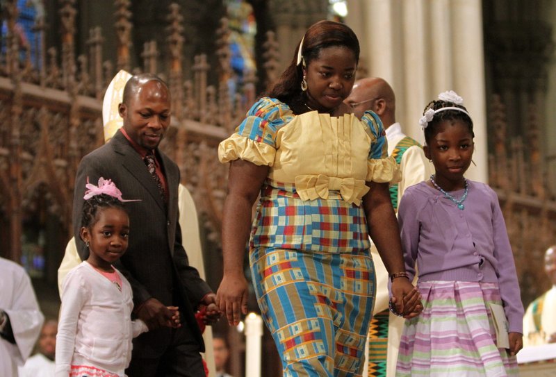 A family is pictured in a file photo after presenting the gifts during Mass at St. Patrick's Cathedral in New York City. National Eucharistic Congress organizers are focusing on making the July event edifying for families, both in content and though logistics. (OSV News photo/Gregory A. Shemitz)