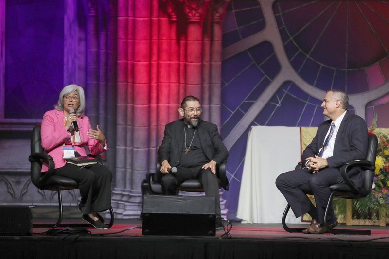 Mabel Suarez from California, Bishop Daniel E. Flores of Brownsville, Texas, and Andrés Arango the emcee, sit in on a July 18, 2024, Encuentro impact session during the National Eucharistic Congress in Indianapolis. (OSV News photo/Bob Roller)