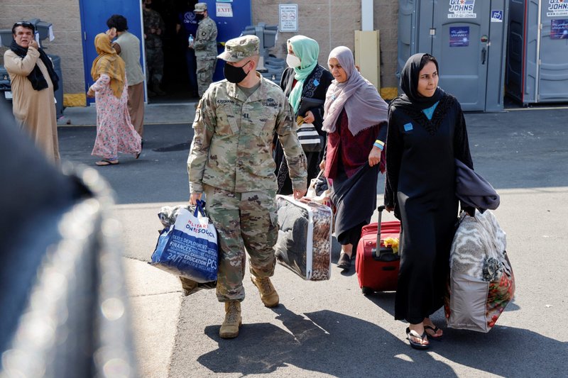 U.S. Army soldiers at the Dulles Expo Center in Chantilly, Va., assist Afghanistan families as they depart an evacuees' processing center Aug. 25, 2021. A federal judge has denied a request from the U.S. Conference of Catholic Bishops to compel the Trump administration to reinstate its contracts with the conference and resume paying it for expenses for resettling refugees in the United States. The bishops are appealing the March 11, 2025, ruling. (OSV News photo/Jonathan Ernst, Reuters)