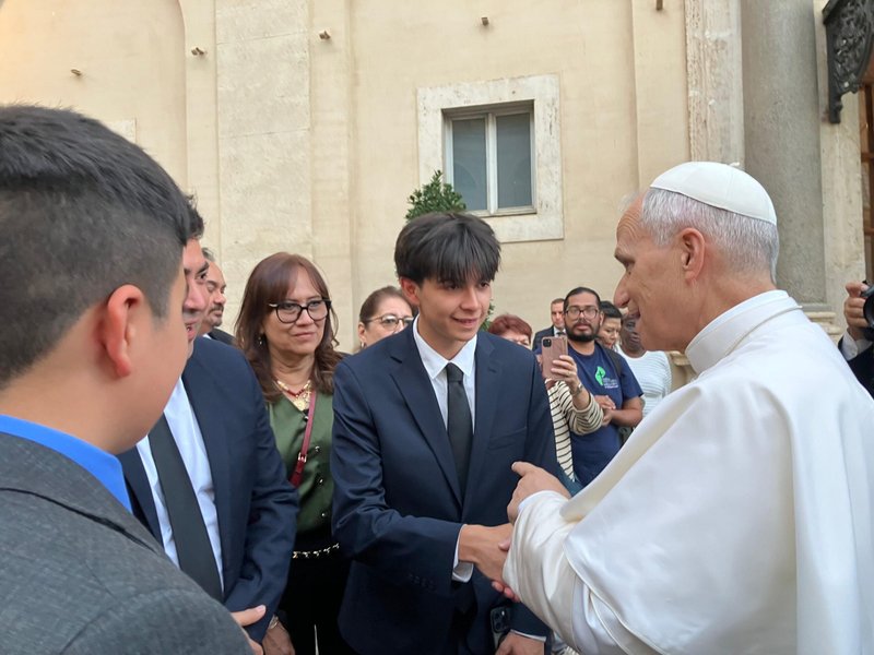 Axel Ruiz greets Pope Leo XIV during a brief meeting the Holy Father had with members of the various groups that make up the Hispanic ministry in the United States. Ruiz traveled with his family from Portland, Oregon, to Rome to participate in the Jubilee of Migrants in early October 2025, on a pilgrimage organized by the National Catholic Council for Hispanic Ministry (NCCHM). (Photo OSV News/courtesy of Koren Ruiz)