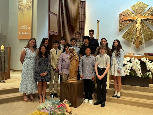 Students at St. Martin of Tours School in Brentwood pose around a crowned statue of the Virgin Mary during a May crowning ceremony. (St. Martin of Tours School)