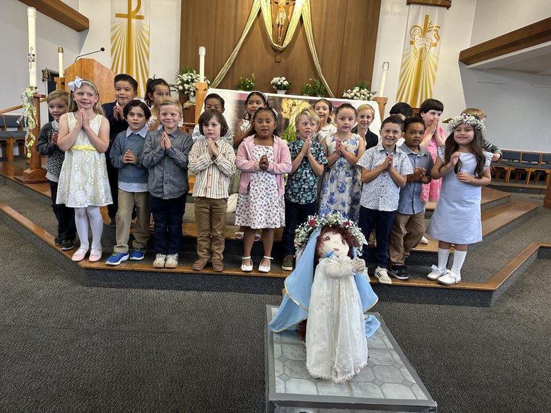 The kindergarten class at St. Raphael School in Santa Barbara poses around a doll of the Virgin Mary for their May crowning event. (St. Raphael School)