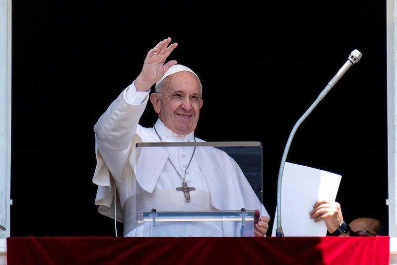 Pope Francis waves as he leads the Angelus from the window of his studio overlooking St. Peter's Square at the Vatican June 30