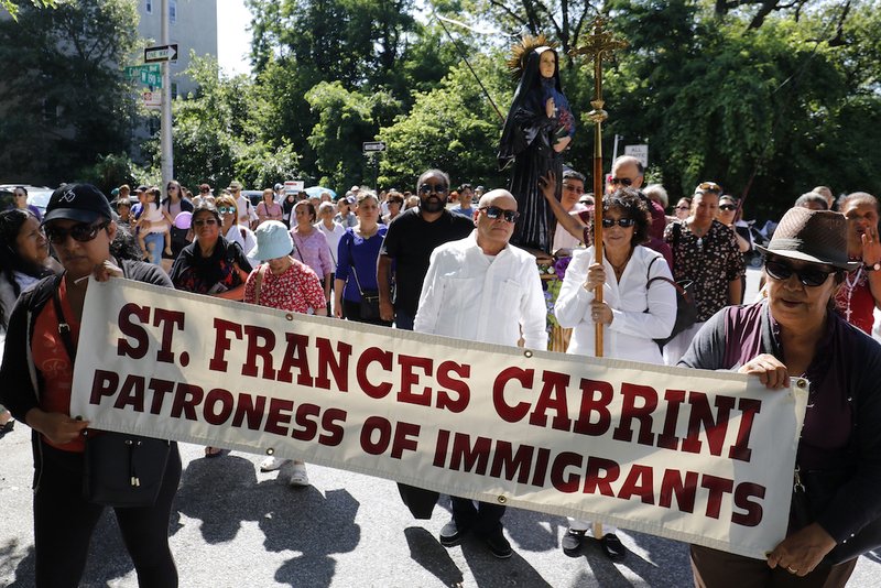People participate in a procession for immigrant rights July 13